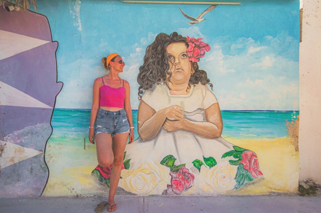 Mexican street soul - murals on Isla Holbox are art, emotion, and color. This one with the girl in white dress and flowers stopped me longer.