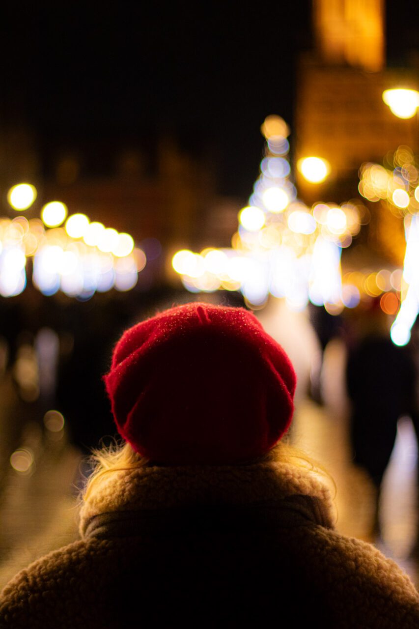 A red hat against a background of Christmas lights