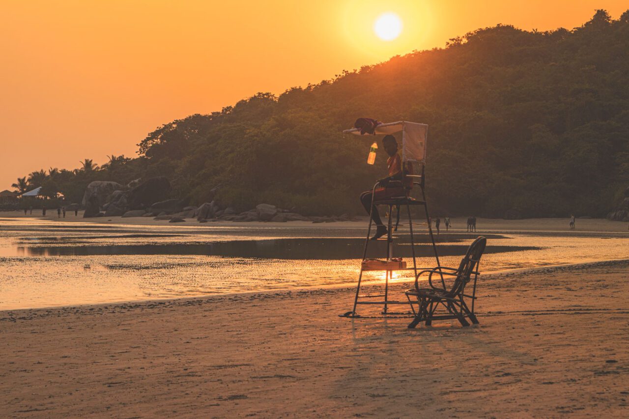 Lifeguard chair and empty beach at sunset in Palolem