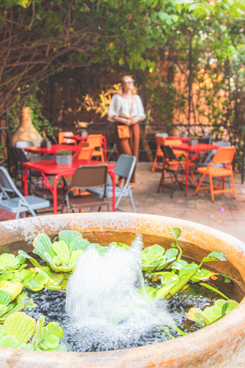 The courtyard at the Casa Arrona hotel, with colorful chairs and a fountain in the foreground.