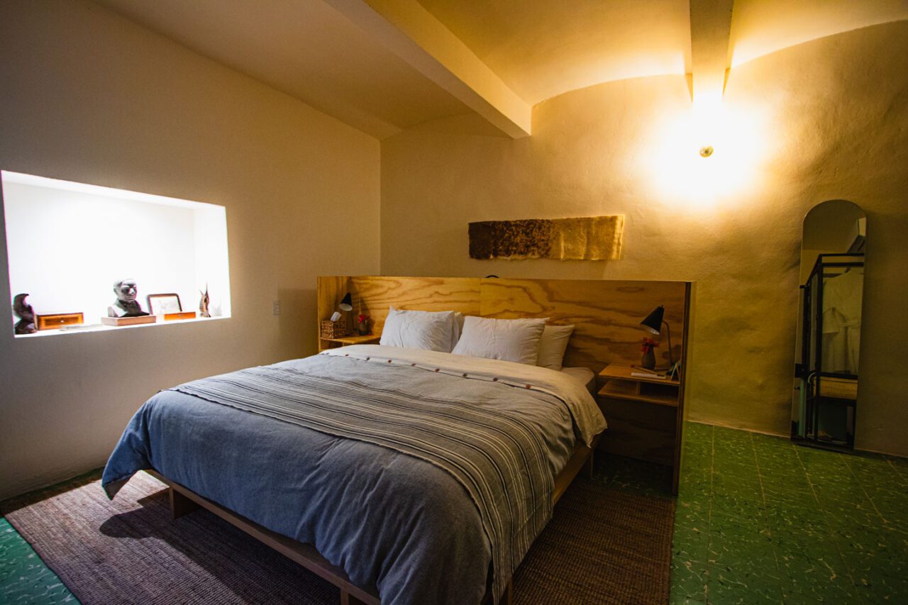 A room in the boutique hotel Casa Arrona Oaxaca with a large bed and minimalist design.