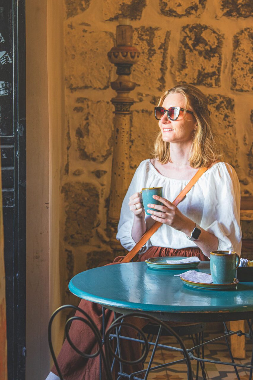 A coffee shop in Oaxaca de Juárez, Mexico, with a cup of coffee and an intimate atmosphere in a historic setting.