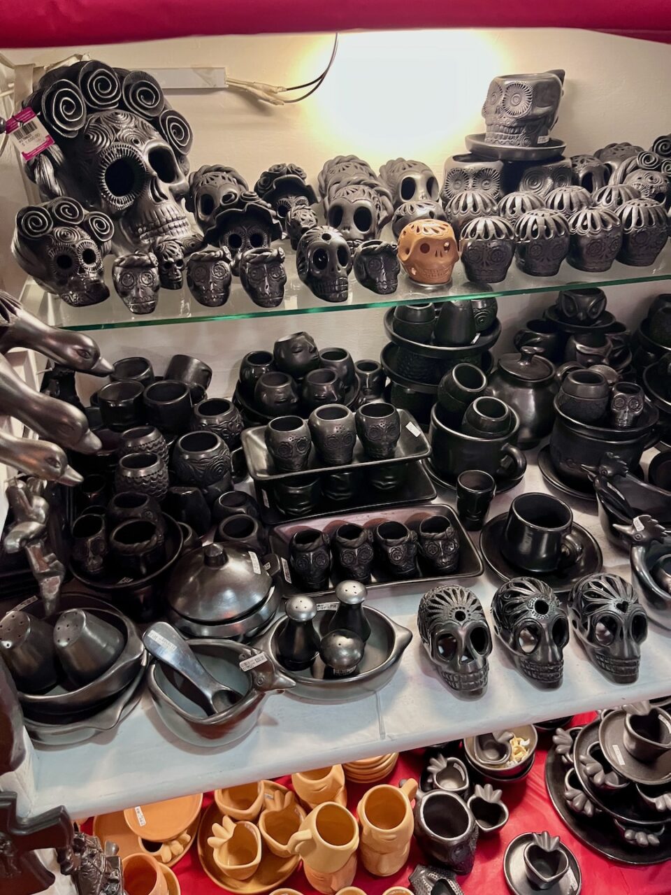 Handmade barro negro pottery from Oaxaca - black vessels and skulls made of fired clay at a local market.
