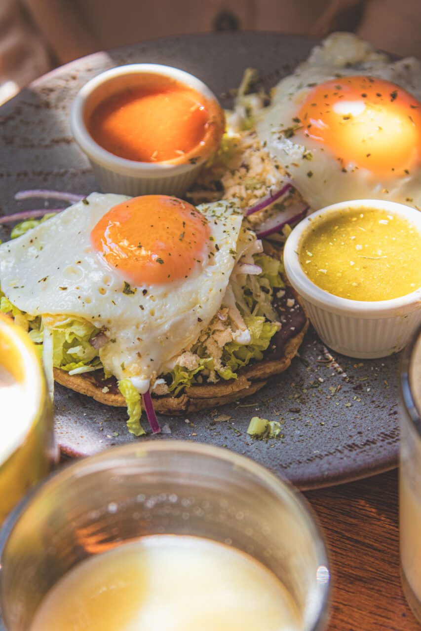 Sopes with fried egg, vegetables, and three salsas served at Café Fortunata in Mexico City.