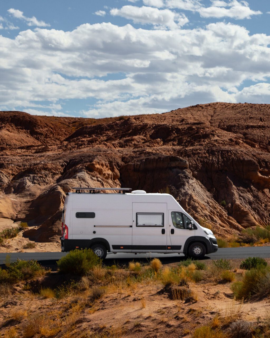 campervan on scenic road through red rock landscape Utah road trip USA