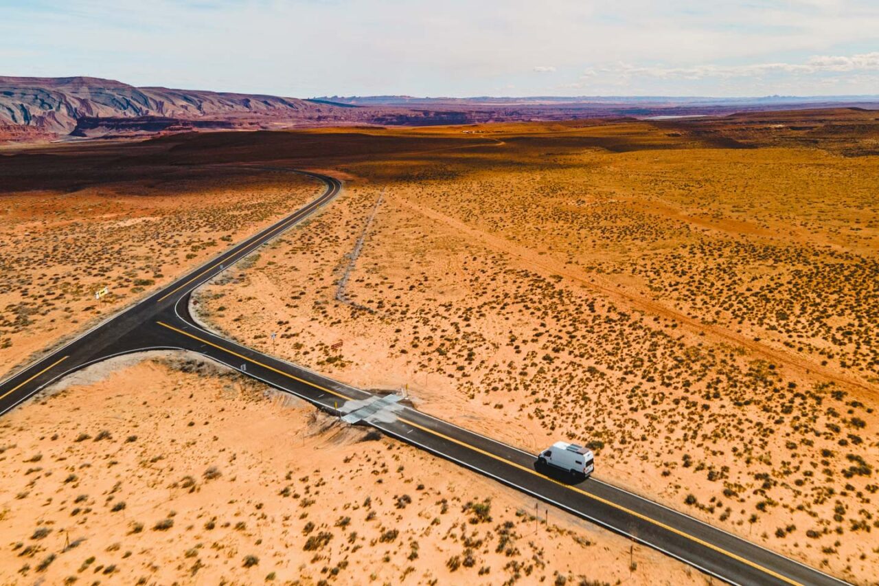 campervan driving on scenic desert road in Utah during a Southwest road trip