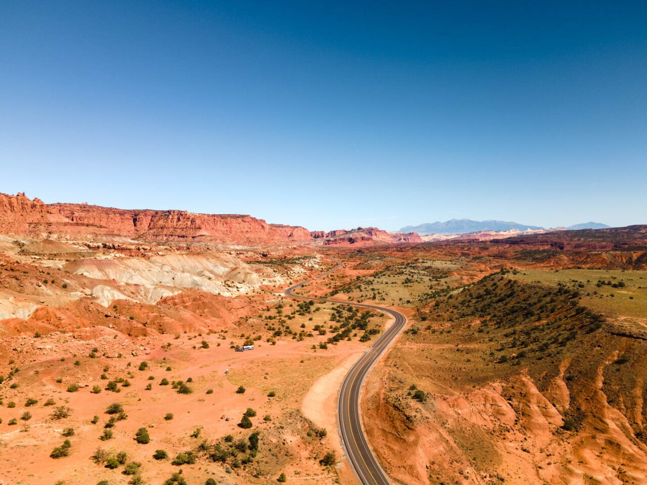 empty desert road in Utah aerial view scenic road trip landscape USA