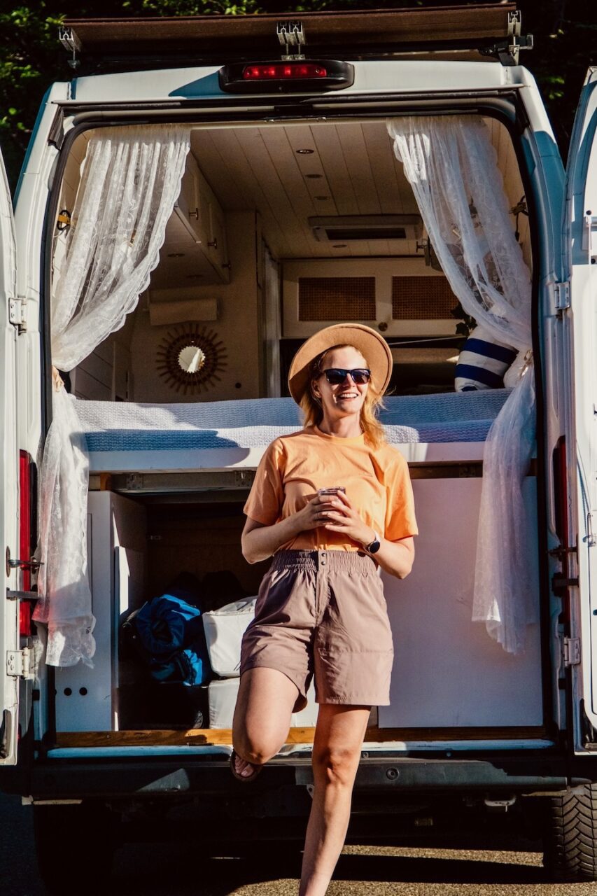 woman relaxing in campervan during slow travel day