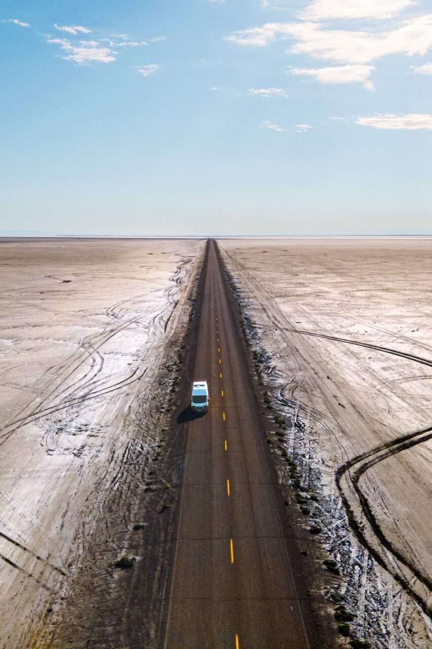 A long, straight road in the USA, seen from above during an RV road trip.
