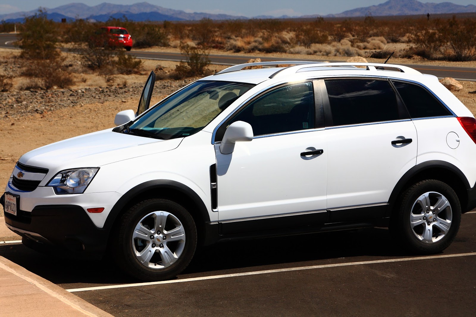 A white Chevrolet Captiva car in the nation park in the western part of the USA