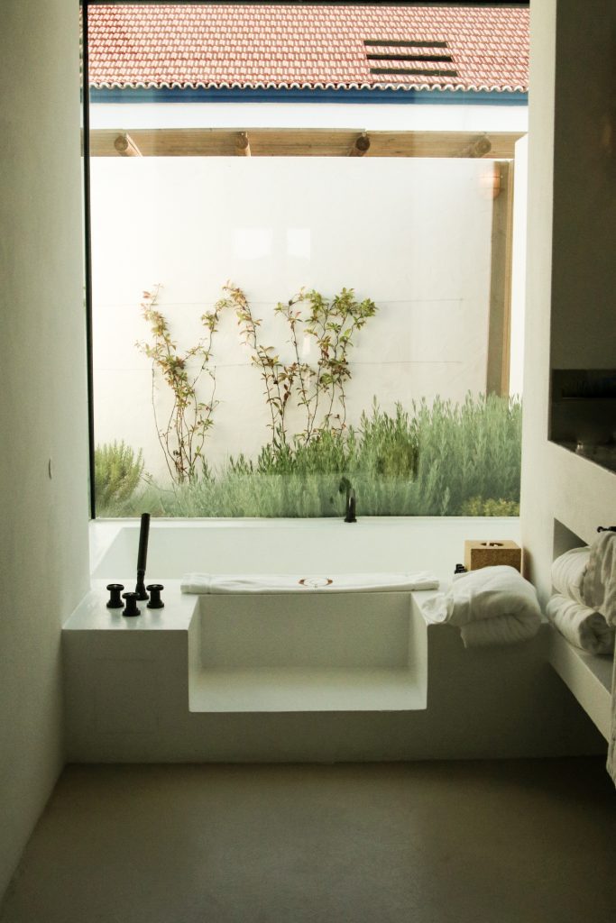 A bathtub overlooking the garden in a room at the Quinta da Comporta Hotel in Portugal