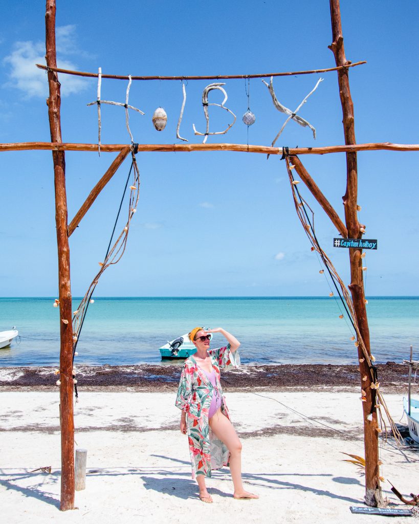 Woman sitting on the beach on Isla Holbox, Quintana Roo, Mexico