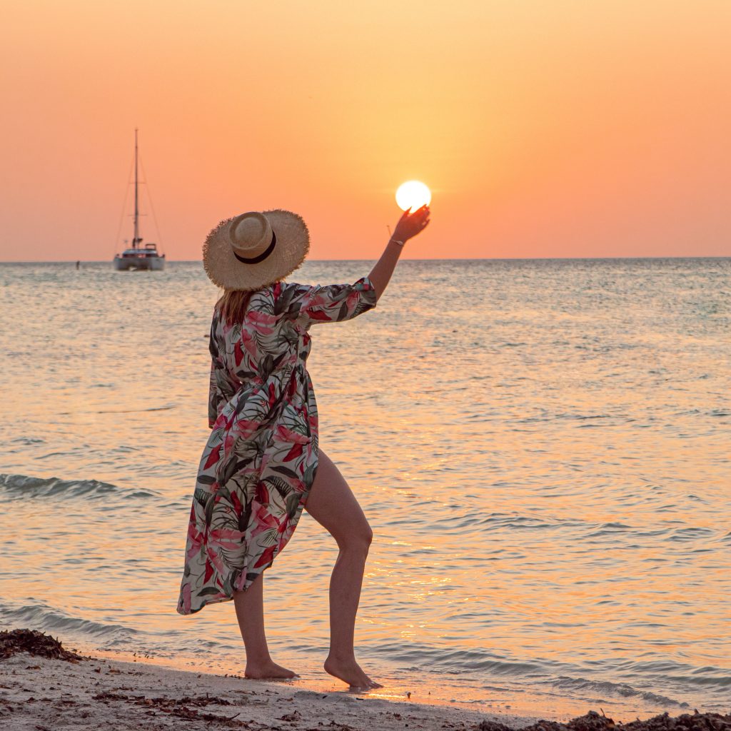 A woman at sunset on the Isla Holbox beach in Mexico