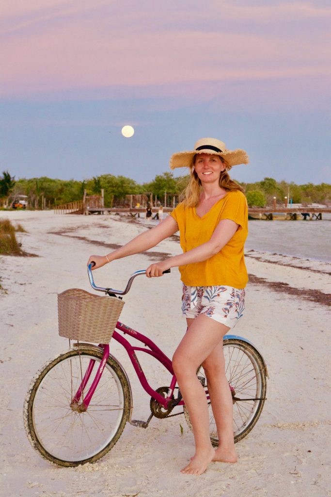 Woman biking in Isla Holbox, Quintana Roo, Mexico