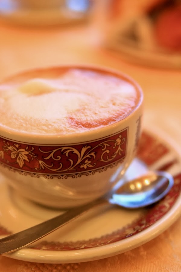Cappuccino e cornetto represents an Italian breakfast classic that's simply irresistible