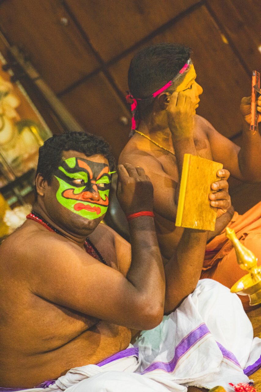 Moments before the kathakali begins - a quiet ritual of colors, gestures, and calm before the storm