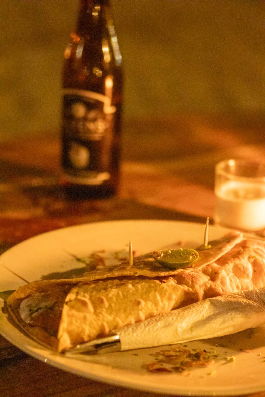 Kolacja przy świecach w Scallywags - chrupiąca tortilla z grillowaną rybą i limonką, idealna po dniu na plaży.