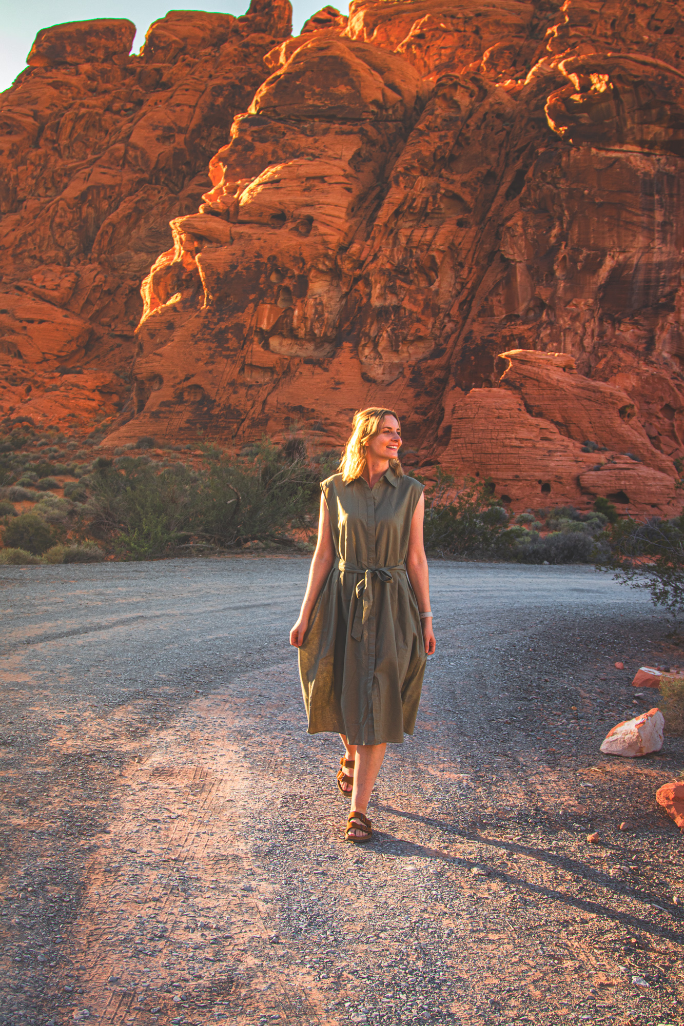 Anna Flik walking on a desert path in Arizona, surrounded by golden light - a soulful travel moment captured in motion.