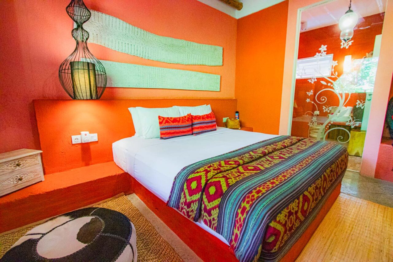 PinkCoco Gili Trawangan hotel room with colorful textiles and soft natural light.