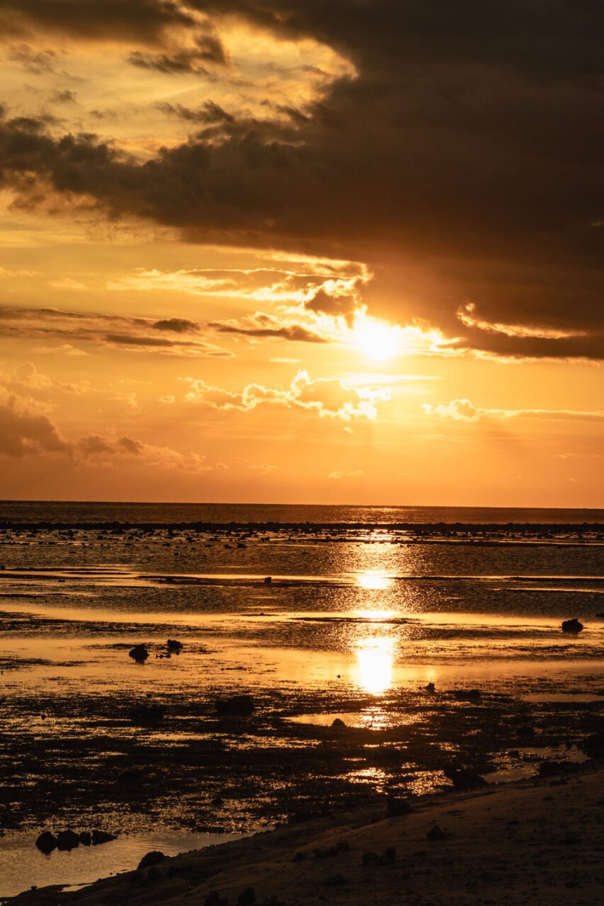 Another sunset on Gili Trawangan - the sky turning liquid gold as the tide gently pulls back, revealing the textured seabed. This is island magic at its finest.