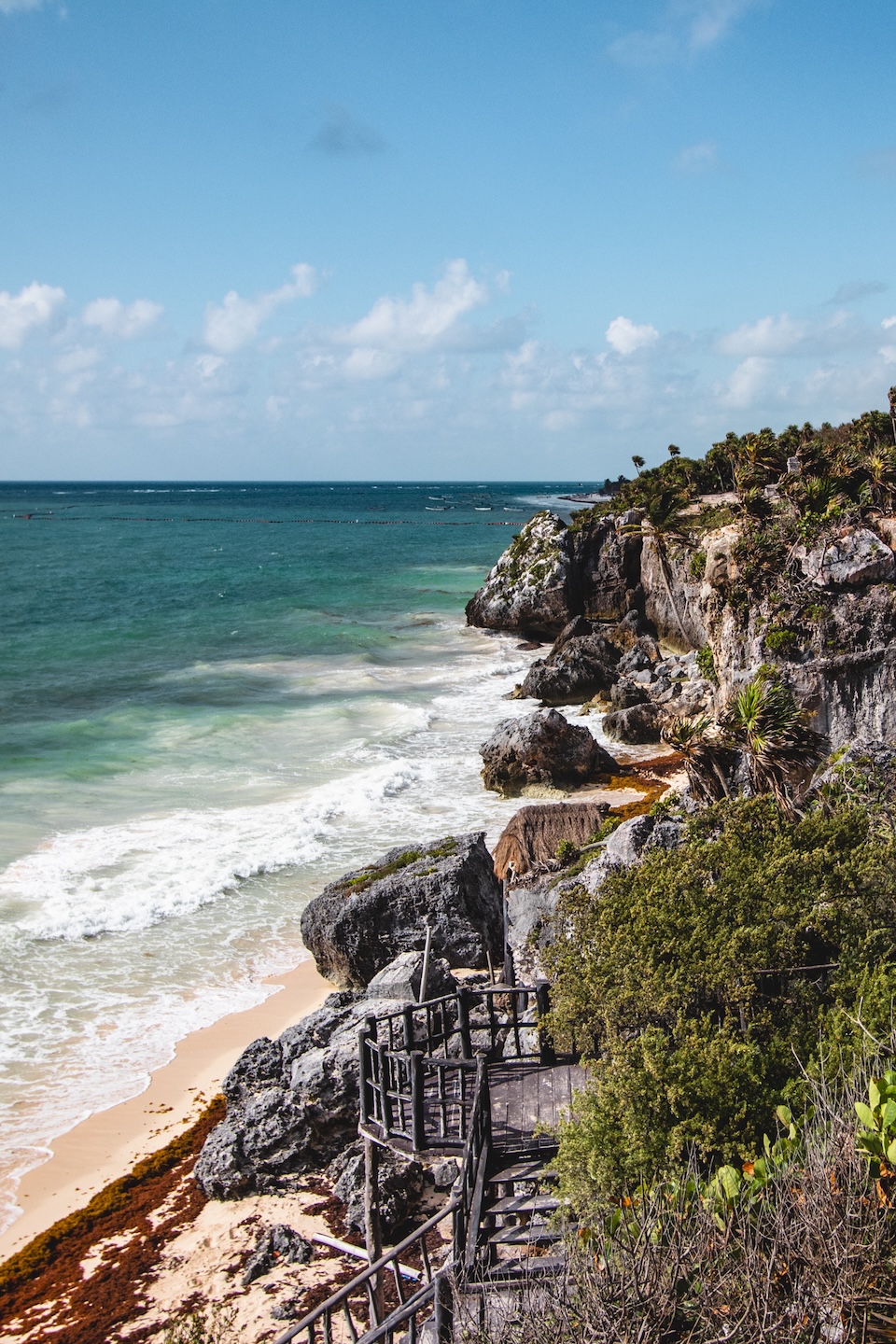 Cliffs and wooden stairs leading to the beach at the Mayan ruins in Tulum, Mexico