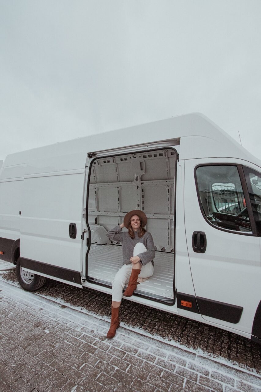 I’m sitting in an empty van before the conversion-the start of a DIY camper build.