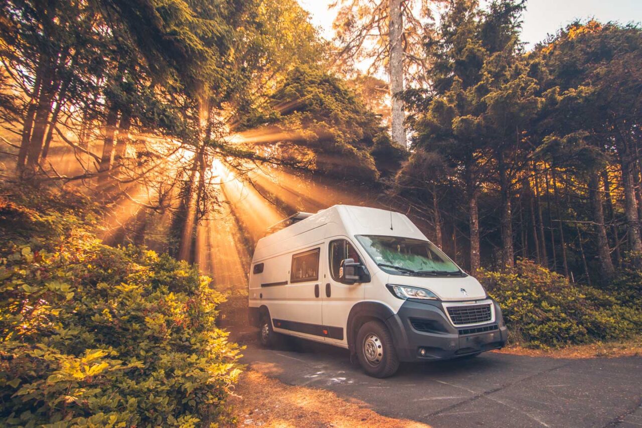 A DIY camper parked at a campsite in the woods in the Pacific Northwest.